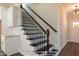 Beautiful stairway with dark wood treads, white risers, and wrought iron railing at 85 Purslane Dr, Franklinton, NC 27525