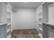 Carpeted walk-in closet with built-in shelving and racks for ample storage at 85 Purslane Dr, Franklinton, NC 27525