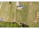 Aerial view of the home, surrounded by a large lawn and wooded areas at 850 Cheatham Mabry Rd, Henderson, NC 27537