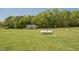 View of huge backyard lawn with utility buildings at 850 Cheatham Mabry Rd, Henderson, NC 27537