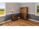 Bedroom with beautiful hardwood floors, ample natural light, and decorative furniture, creating a bright and appealing interior at 850 Cheatham Mabry Rd, Henderson, NC 27537