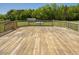 Expansive wood deck overlooking a large lawn area with mature trees in the distance at 850 Cheatham Mabry Rd, Henderson, NC 27537