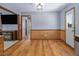 Spacious dining area features hardwood floors, wood paneling, and access to adjacent rooms at 850 Cheatham Mabry Rd, Henderson, NC 27537