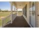 Inviting front porch with wood flooring, white railings, and a view of the pasture at 850 Cheatham Mabry Rd, Henderson, NC 27537
