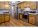 Cozy kitchen features wood cabinets, stainless steel appliances and hardwood floors at 850 Cheatham Mabry Rd, Henderson, NC 27537