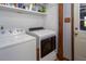 Bright laundry room with washer, dryer, and built-in shelving for ample storage at 850 Cheatham Mabry Rd, Henderson, NC 27537