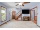 Bright living room with a fireplace, stairs, hardwood and carpet, featuring an open floor plan and comfortable living space at 850 Cheatham Mabry Rd, Henderson, NC 27537