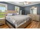 Main bedroom with a large bed, matching dressers and nightstands, showcasing a tranquil space with backyard views at 850 Cheatham Mabry Rd, Henderson, NC 27537