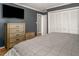 Bedroom featuring gray walls, carpet, a closet, and a dresser with a large TV for ultimate comfort at 850 Cheatham Mabry Rd, Henderson, NC 27537