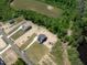 Aerial view of two homes on adjacent lots, highlighting the landscaping, trees, and surrounding terrain at 8620 Dukes Lake Rd, Zebulon, NC 27597