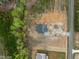Aerial view of new construction home site surrounded by green trees at 8620 Dukes Lake Rd, Zebulon, NC 27597