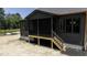 Charming back porch with wooden deck, dark posts and black railing at 8620 Dukes Lake Rd, Zebulon, NC 27597