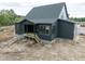 New construction home with gray siding and an in-progress backyard at 8620 Dukes Lake Rd, Zebulon, NC 27597