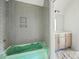 Bathroom showcasing a modern gray herringbone tiled wall and shower area at 8620 Dukes Lake Rd, Zebulon, NC 27597