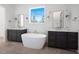 This bathroom features dual sink vanities, a freestanding tub, and luxurious fixtures at 8620 Dukes Lake Rd, Zebulon, NC 27597