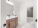 Bathroom with a vanity, herringbone shower tile and a large mirror at 8620 Dukes Lake Rd, Zebulon, NC 27597