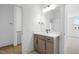 Bathroom boasts a modern vanity with ample storage, sleek fixtures, and leads to another room at 8620 Dukes Lake Rd, Zebulon, NC 27597