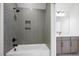 Modern bathroom features a shower with stylish gray tiling and updated fixtures at 8620 Dukes Lake Rd, Zebulon, NC 27597