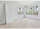 Unfurnished bedroom with large windows offering ample natural light and a serene view at 8620 Dukes Lake Rd, Zebulon, NC 27597