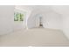 Bright bedroom features plush carpeting, large windows, and an open doorway at 8620 Dukes Lake Rd, Zebulon, NC 27597
