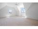 Spacious bedroom with large windows, ceiling fan, and vaulted ceiling is ready for flooring at 8620 Dukes Lake Rd, Zebulon, NC 27597