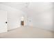 Minimalist bedroom with neutral carpet and multiple doors leading to other rooms at 8620 Dukes Lake Rd, Zebulon, NC 27597