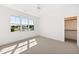 Bright bedroom features plush carpeting, large windows, and a walk-in closet at 8620 Dukes Lake Rd, Zebulon, NC 27597