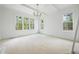 Bright bedroom featuring recessed lights, beamed ceiling and large windows at 8620 Dukes Lake Rd, Zebulon, NC 27597