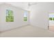 Bright and spacious bedroom with natural light from two windows and neutral carpet at 8620 Dukes Lake Rd, Zebulon, NC 27597