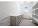 Bright butler's pantry with countertop, storage cabinets, and open shelving at 8620 Dukes Lake Rd, Zebulon, NC 27597