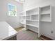 Bright butler's pantry featuring white shelves and a large window for natural light at 8620 Dukes Lake Rd, Zebulon, NC 27597