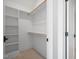 Empty closet with built-in shelving and hanging rods awaiting your personal organization at 8620 Dukes Lake Rd, Zebulon, NC 27597