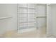 Walk-in closet featuring custom shelving and ample space for storage and organization at 8620 Dukes Lake Rd, Zebulon, NC 27597