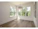 Bright dining area with large windows offering picturesque outdoor views and hardwood flooring at 8620 Dukes Lake Rd, Zebulon, NC 27597