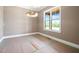 Bright dining room featuring a large window and elegant chandelier fixture at 8620 Dukes Lake Rd, Zebulon, NC 27597