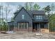 New construction home features dark siding, copper gutters and brick foundation at 8620 Dukes Lake Rd, Zebulon, NC 27597