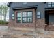 Brick foundation of new construction home featuring three large windows at 8620 Dukes Lake Rd, Zebulon, NC 27597