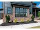 Close-up of the exterior reveals a brick base, trimmed windows and a well-manicured landscape at 8620 Dukes Lake Rd, Zebulon, NC 27597