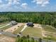 New home with a dark roof, gray siding and a beautiful green lawn in a wooded area at 8620 Dukes Lake Rd, Zebulon, NC 27597