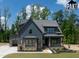 Two-story home showcases a mixed material facade, complemented by a lush lawn and professional landscaping at 8620 Dukes Lake Rd, Zebulon, NC 27597