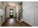 Bright foyer features hardwood floors, staircase, and wood door with glass at 8620 Dukes Lake Rd, Zebulon, NC 27597