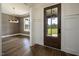 Elegant foyer boasts wood floors, a chandelier, and view into the dining room at 8620 Dukes Lake Rd, Zebulon, NC 27597