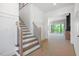 Open Foyer with staircase leading to the upper level and views to the outdoor living area at 8620 Dukes Lake Rd, Zebulon, NC 27597