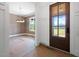 Light-filled foyer featuring a wood door and an adjacent room with large windows at 8620 Dukes Lake Rd, Zebulon, NC 27597