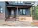 New construction home with front door with glass and brick steps at 8620 Dukes Lake Rd, Zebulon, NC 27597