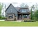 Charming two-story home featuring a mix of siding and brick with an inviting front porch and lush landscaping at 8620 Dukes Lake Rd, Zebulon, NC 27597