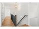 Hallway with hardwood floors, a railing, and a decorative hanging light fixture at 8620 Dukes Lake Rd, Zebulon, NC 27597