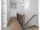 Hallway with a wooden railing and luxury light fixture is being prepared for a new floor installation at 8620 Dukes Lake Rd, Zebulon, NC 27597
