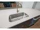 Close-up of the kitchen island sink featuring stainless steel sink and white countertops at 8620 Dukes Lake Rd, Zebulon, NC 27597