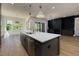 Spacious kitchen with a large island, stainless steel appliances, and a seamless flow to the living area at 8620 Dukes Lake Rd, Zebulon, NC 27597
